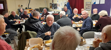 ek mens shed members enjoying a fish supper